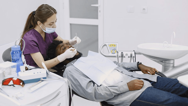 Lady dentist is operating a patient in dental clinic