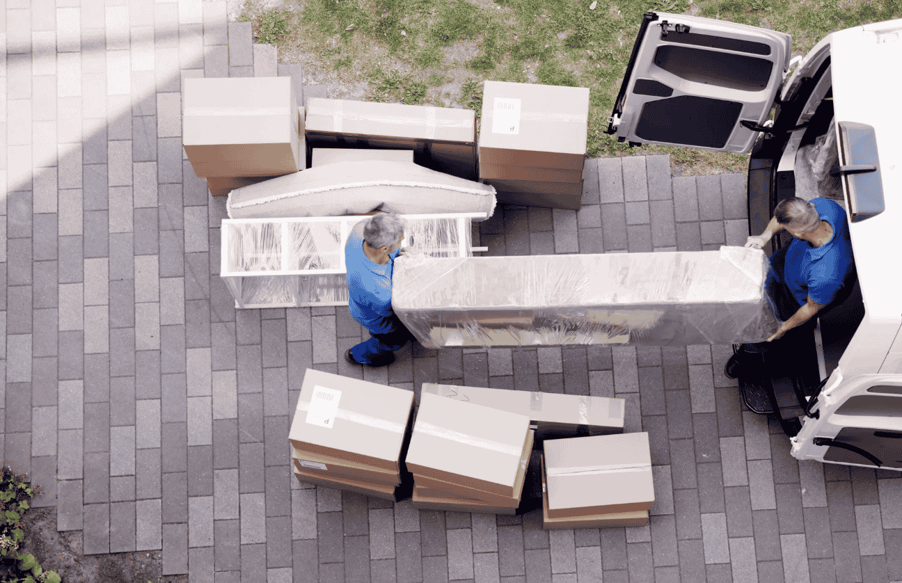Two men lifting the home goods
