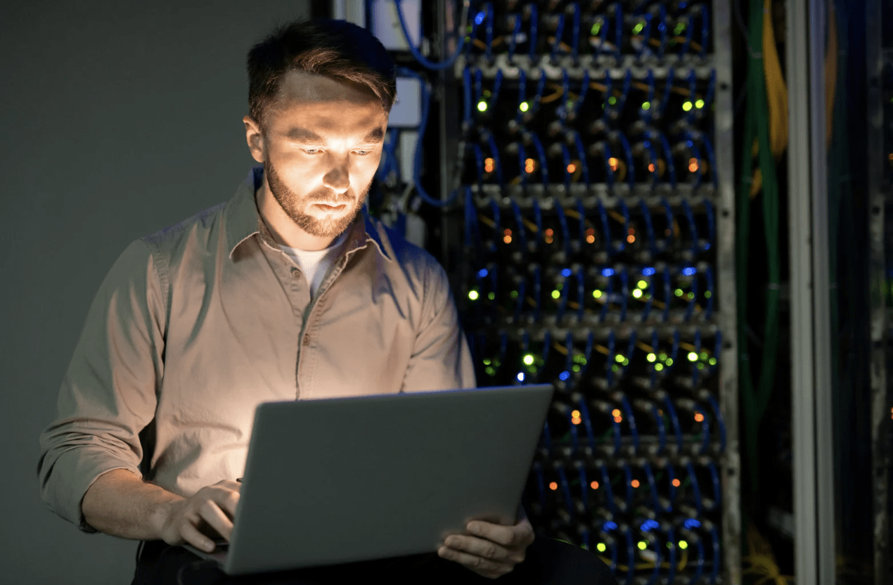 The image contains an IT services manager with a server machine