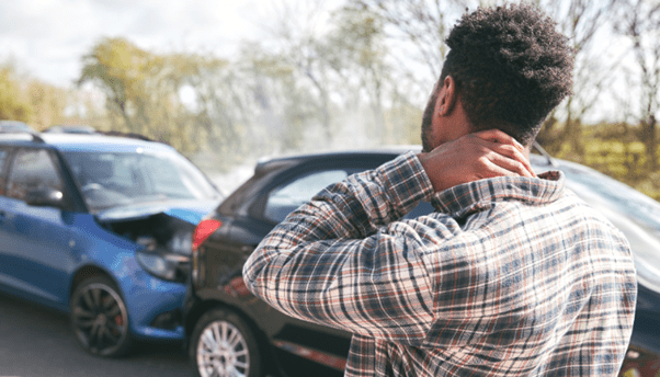 A Man is holding his whiplash.
