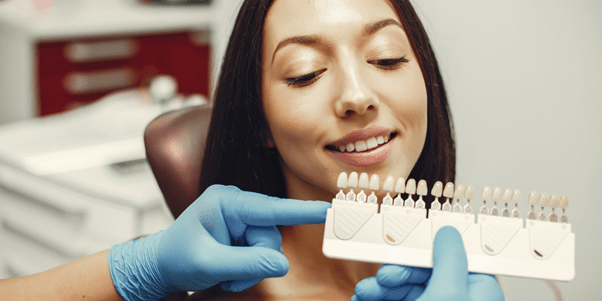 A lady patient is watching at Porcelain Veneers