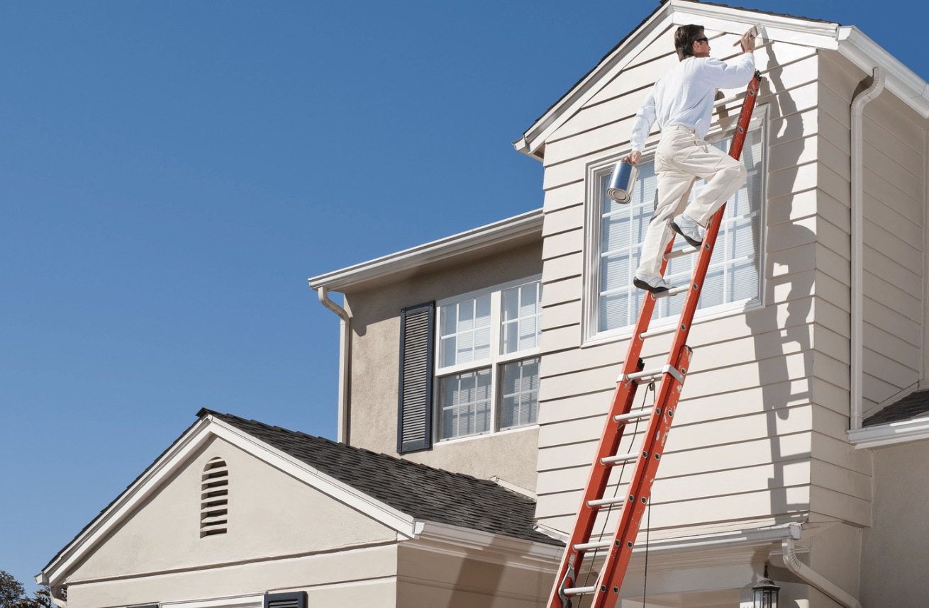 Exterior painting contractor is painting a home exterior