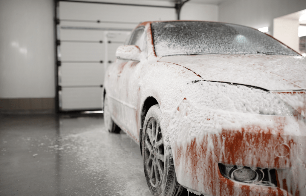 A car is getting washed and serviced after being damaged by a hailstorm