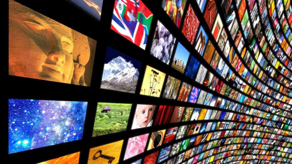 A curved wall displaying a vast collection of active screens with vibrant content