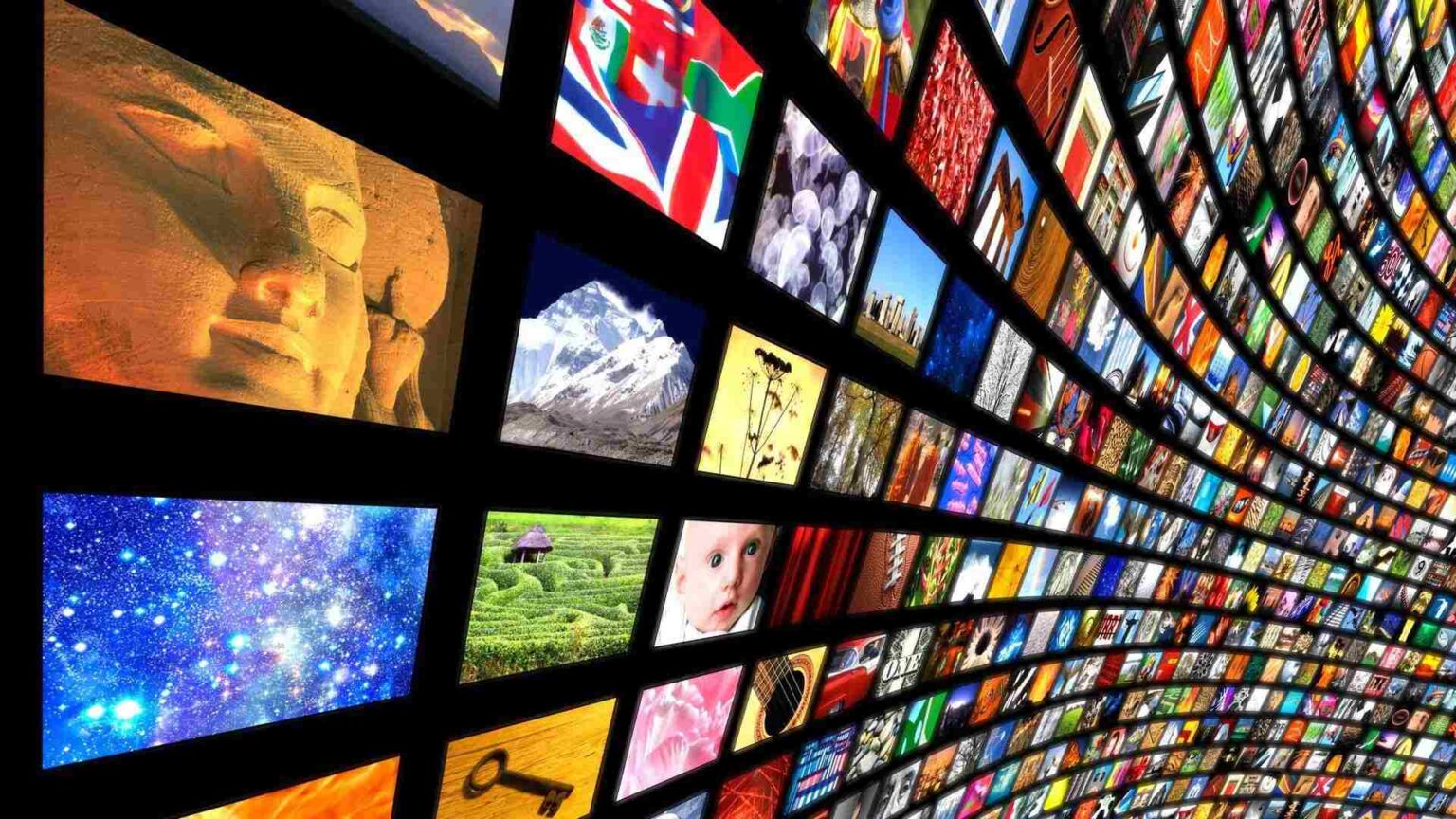 A curved wall displaying a vast collection of active screens with vibrant content
