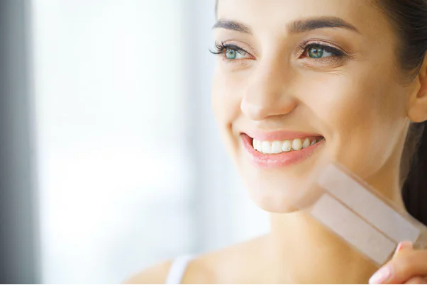 A women smiling after teeth whitening treatment